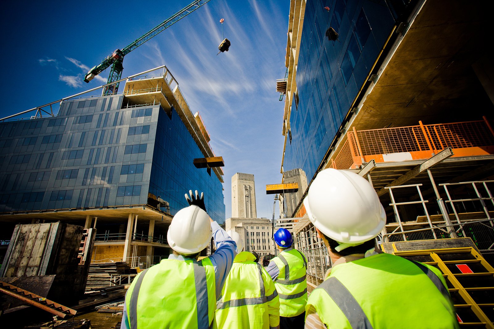 guys staring up at a crane